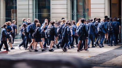 A group of students entering the Immigration Museum from the courtyard.